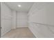 Walk-in closet with carpeted floors and adjustable shelving units at 717 Tailrace Falls Ct, Wake Forest, NC 27587