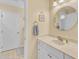 Bathroom featuring a classic vanity with a neutral countertop, well-lit mirror, and decorative fixtures at 7305 Sandy Creek Dr, Raleigh, NC 27615