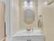 Updated half-bath features vanity with a sink, round mirror, and new light fixture at 7305 Sandy Creek Dr, Raleigh, NC 27615