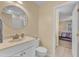 Clean bathroom featuring a classic vanity, well-lit mirror, and convenient access to the bedroom at 7305 Sandy Creek Dr, Raleigh, NC 27615