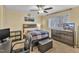 Cozy bedroom with a double bed, dresser, and large window that lets in a lot of natural light at 7305 Sandy Creek Dr, Raleigh, NC 27615