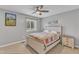 Comfortable bedroom featuring neutral walls, a ceiling fan, a well-lit window and a quilt-patterned bed at 7305 Sandy Creek Dr, Raleigh, NC 27615