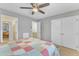 Bright bedroom featuring neutral walls, a ceiling fan, and spacious closets for ample storage solutions at 7305 Sandy Creek Dr, Raleigh, NC 27615