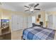 Bright bedroom featuring neutral walls, ceiling fan, and spacious closets for ample storage solutions at 7305 Sandy Creek Dr, Raleigh, NC 27615