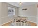 Bright dining area with hardwood floors, natural light, and neutral wall color at 7305 Sandy Creek Dr, Raleigh, NC 27615