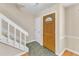 Inviting foyer with a decorative front door and staircase to the upper level at 7305 Sandy Creek Dr, Raleigh, NC 27615