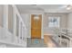Light filled foyer with a decorative wood door, ceramic tile flooring and stairwell at 7305 Sandy Creek Dr, Raleigh, NC 27615