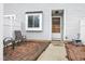 Charming front entrance with a brick patio, seating and light grey siding at 7305 Sandy Creek Dr, Raleigh, NC 27615
