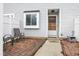 Inviting front porch with brick pavers and seating area, next to the front door of the townhouse at 7305 Sandy Creek Dr, Raleigh, NC 27615