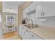 Bright kitchen features white cabinets, subway tile backsplash, and stainless steel sink at 7305 Sandy Creek Dr, Raleigh, NC 27615