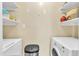 The laundry room provides ample storage with built-in shelving units and modern appliances at 7305 Sandy Creek Dr, Raleigh, NC 27615