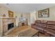 Spacious living room with stone fireplace, a large screen TV, and wood laminate floors at 7305 Sandy Creek Dr, Raleigh, NC 27615