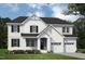 Elegant new construction home boasts white brick, black shutters, and a two-car garage at 74 Alex Farm Ct # 22, Zebulon, NC 27597