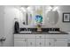 Bathroom with dual sinks, dark countertops and modern fixtures at 9501 Coachway, Chapel Hill, NC 27516