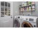 Functional laundry room with washer, dryer and shelving for storage at 9501 Coachway, Chapel Hill, NC 27516