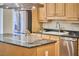 Modern kitchen featuring stainless steel appliances, granite countertops, and an island at 1 Bland Spring Pl, Durham, NC 27713