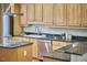 Well-lit kitchen featuring granite countertops, stainless steel appliances, and custom cabinets at 1 Bland Spring Pl, Durham, NC 27713