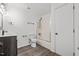 Well-lit bathroom with a shower-tub combo, dark vanity, and modern fixtures, providing functionality at 1001 Atchison St, Garner, NC 27529