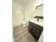 Bathroom featuring a shower-tub combo, vanity with a wooden cabinet, mirror, and toilet at 1001 Atchison St, Garner, NC 27529