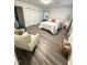 Comfortable bedroom featuring neutral tones, natural lighting, and organized closet at 1001 Atchison St, Garner, NC 27529