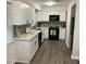 Stylish kitchen featuring white cabinets, stainless steel appliances and unique backsplash at 1001 Atchison St, Garner, NC 27529