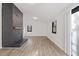 Bright living room with wood floors and a black brick fireplace adding a modern touch at 1001 Atchison St, Garner, NC 27529