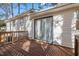 Exterior view showcasing a wooden back deck, sliding glass doors, and white siding at 1001 Atchison St, Garner, NC 27529