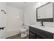 Bright bathroom features a shower-tub combo and modern vanity with sleek black fixtures at 1001 Atchison St, Garner, NC 27529