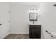 Freshly renovated bathroom featuring modern vanity with dark wood finish, new fixtures, and sleek lighting at 1001 Atchison Street St, Garner, NC 27529