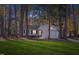 Well-maintained home surrounded by mature trees and lush green lawn creating a serene and inviting atmosphere at 1001 Atchison St, Garner, NC 27529