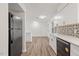 Kitchen features white cabinets, stainless appliances, decorative backsplash, and open layout at 1001 Atchison St, Garner, NC 27529