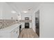Bright kitchen with white cabinets, stainless appliances, black accents, and decorative tile backsplash at 1001 Atchison St, Garner, NC 27529