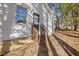 Side entrance to a home with small porch and brick foundation with tidy landscaping at 1001 Atchison St, Garner, NC 27529