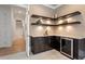 Elegant bar area featuring custom cabinetry, granite countertops, and wine refrigerator at 1001 Welch Ln, Raleigh, NC 27614