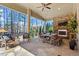 Covered patio featuring a stone fireplace, ceiling fan, and a dining table with seating at 1001 Welch Ln, Raleigh, NC 27614
