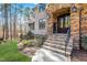 Stone steps lead to an elegant entryway with a dark wood door and stone surround at 1001 Welch Ln, Raleigh, NC 27614