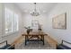 Bright home office featuring natural light, a wooden desk, and wainscoting, perfect for a productive workspace at 1001 Welch Ln, Raleigh, NC 27614