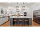 Modern kitchen showcasing a large central island with bar seating, stainless appliances, and custom cabinetry at 1001 Welch Ln, Raleigh, NC 27614