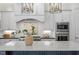 Close up of the island featuring a white quartz countertop and a tile backsplash at 1001 Welch Ln, Raleigh, NC 27614