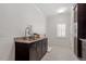 Convenient laundry room with granite countertops, a stainless steel faucet, and custom cabinets at 1001 Welch Ln, Raleigh, NC 27614