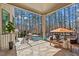Beautiful outdoor patio with stone flooring, seating area, and views of the pool and surrounding trees at 1001 Welch Ln, Raleigh, NC 27614