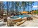 Luxury pool and hot tub area with stone accents, offering a perfect backyard oasis at 1001 Welch Ln, Raleigh, NC 27614