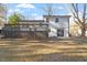 Exterior view of the home with a large deck and spacious backyard with mature trees at 1004 Helms Pl, Raleigh, NC 27610