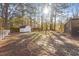 View of a large backyard with mature trees and a storage shed at 1004 Helms Pl, Raleigh, NC 27610