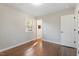 Simple bedroom with hardwood floors and natural light from the window at 1004 Helms Pl, Raleigh, NC 27610
