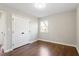 Bedroom with hardwood floors and closet; lots of natural light from the window at 1004 Helms Pl, Raleigh, NC 27610