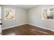 Bright bedroom with hardwood floors and two windows allowing for natural light at 1004 Helms Pl, Raleigh, NC 27610