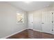 Bright bedroom with hardwood floors, closet space, and a window with a view at 1004 Helms Pl, Raleigh, NC 27610