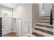 Bright entryway features wood floors, staircase, and ample natural light, offering a welcoming transition at 1004 Helms Pl, Raleigh, NC 27610