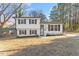 Charming two-story home featuring a white facade, contrasting shutters, and a well-maintained front yard at 1004 Helms Pl, Raleigh, NC 27610